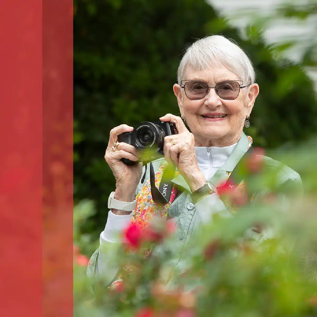 woman taking pictures and enjoying nature at Glenmeadow Retirement Community